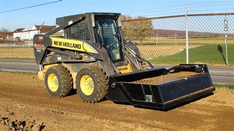 john deere skid steer with a power rake|dirt rake for skid steer.